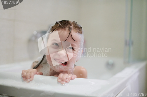 Image of little girl in bath playing with soap foam