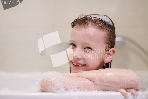 Image of little girl in bath playing with soap foam