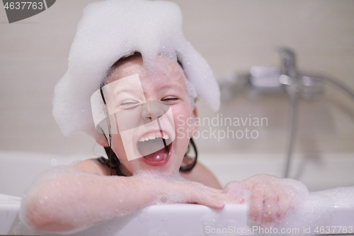 Image of little girl in bath playing with soap foam