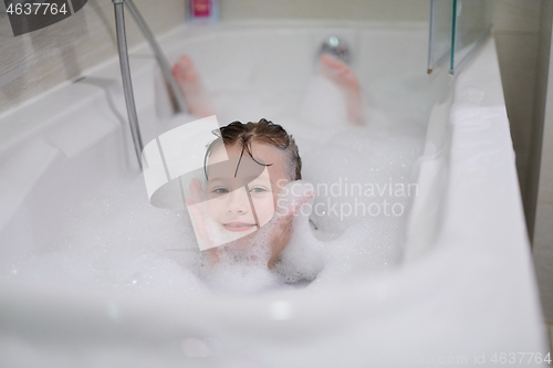 Image of little girl in bath playing with soap foam