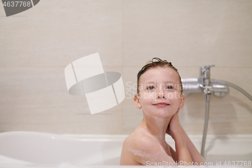 Image of little girl in bath playing with soap foam