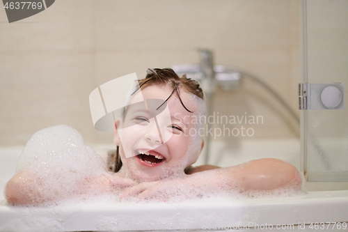 Image of little girl in bath playing with soap foam