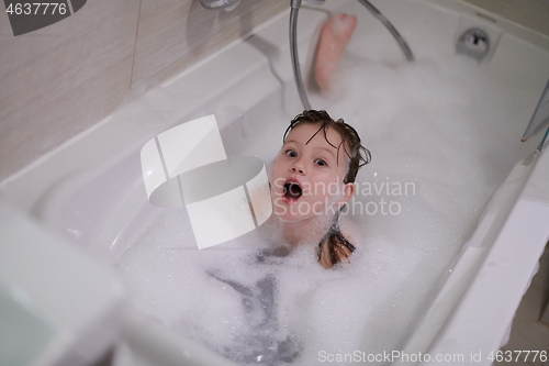 Image of little girl in bath playing with soap foam