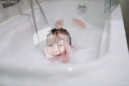 Image of little girl in bath playing with soap foam