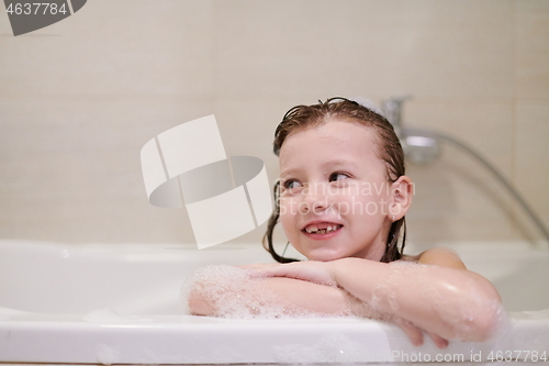 Image of little girl in bath playing with soap foam