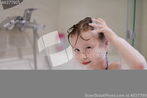 Image of little girl in bath playing with soap foam