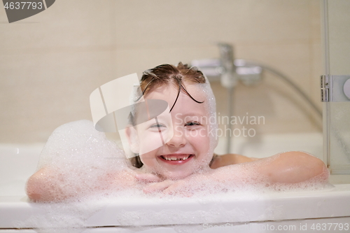 Image of little girl in bath playing with soap foam