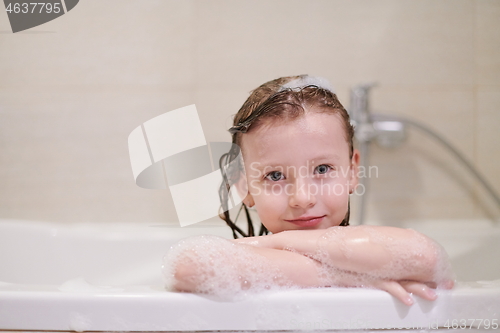 Image of little girl in bath playing with soap foam