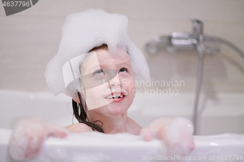 Image of little girl in bath playing with soap foam