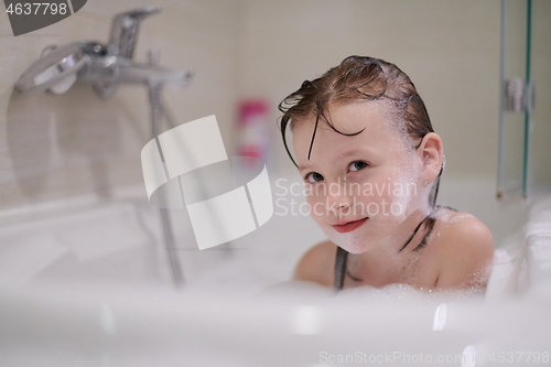 Image of little girl in bath playing with soap foam