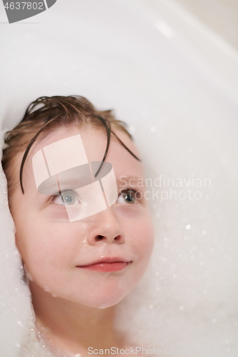 Image of little girl in bath playing with soap foam