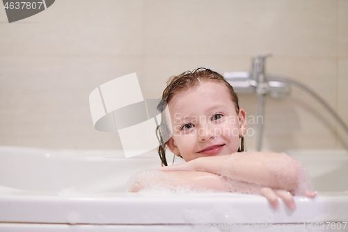 Image of little girl in bath playing with soap foam