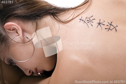 Image of Tattoo on a back of the young woman. Isolated 2