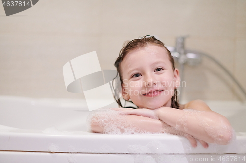 Image of little girl in bath playing with soap foam