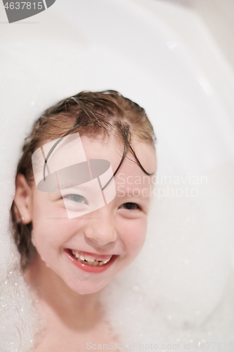 Image of little girl in bath playing with soap foam