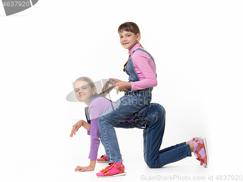 Image of Two girls play horse on a white background