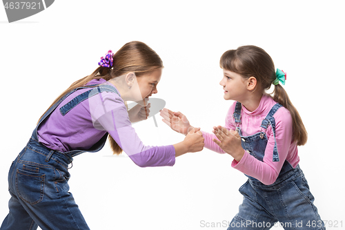 Image of two girls quarrel and fight with each other on a white background