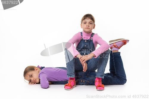 Image of Two sad girls rest sitting and lying on a white background