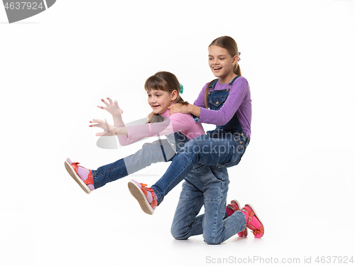 Image of Hilarious girl rides on herself riding her sister on a white background