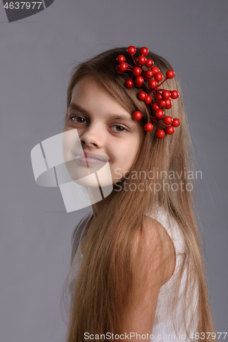 Image of Portrait of a ten year old girl with a bunch of berries in her hair