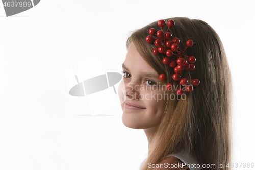 Image of Closeup portrait of a ten year old girl with a bunch of berries in her hair