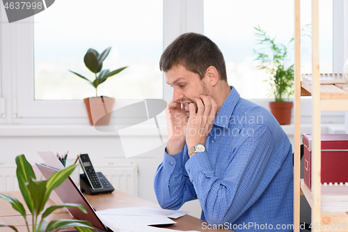 Image of Office worker bites her nails while looking at the monitor screen