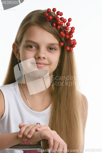 Image of Portrait of a girl of Slavic appearance with a bunch of berries in her hair close-up