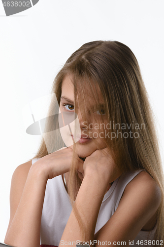 Image of Beautiful girl with long blond hair covering part of the face