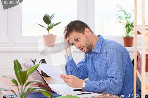 Image of Office clerk horrified by what is written in the document