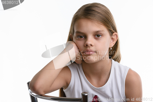 Image of Portrait of a pensive ten year old girl on a white background