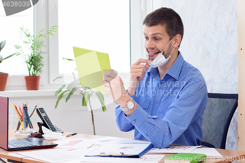 Image of Cheerful office employee communicates with partners by video link and shows the language