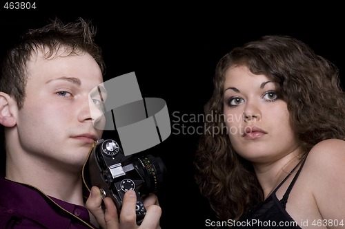 Image of Photographer and young model. Isolated on black
