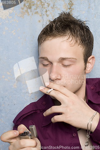 Image of portrait of the young man with a cigarette and a lighter