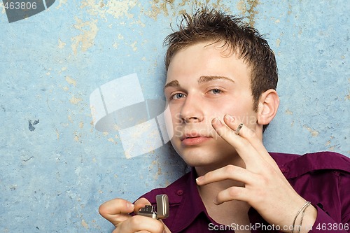 Image of portrait of the young man with a cigarette and a lighter 2