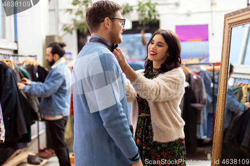 Image of couple choosing clothes at vintage clothing store