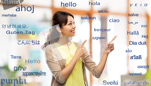 Image of asian woman pointing fingers to foreign words