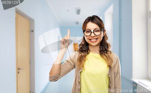 Image of asian woman or student with finger up at school