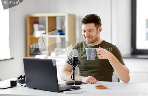 Image of blogger with laptop and microphone audio blogging