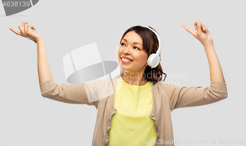 Image of asian woman in headphones listening to music