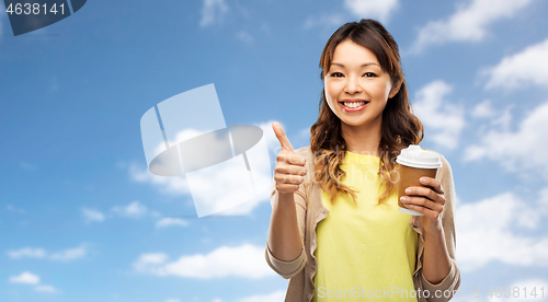 Image of asian woman drinking coffee and showing thumbs up