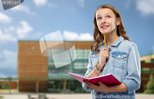 Image of teenage student girl with notebook over school