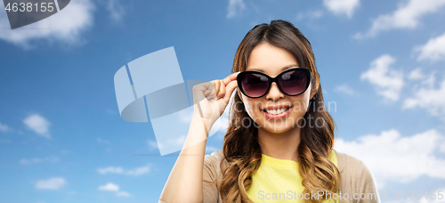 Image of happy smiling young asian woman in sunglasses