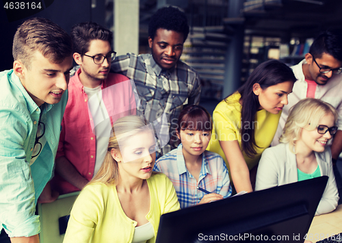 Image of international students with computers at library