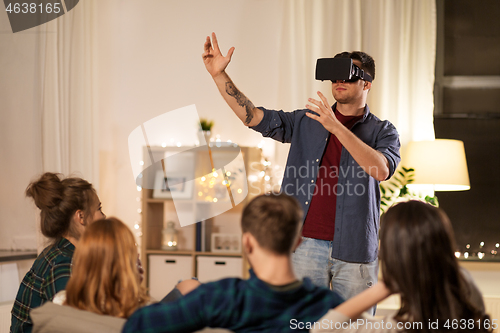 Image of man in vr glasses at home with friends