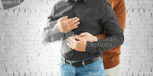 Image of close up of hugging male gay couple