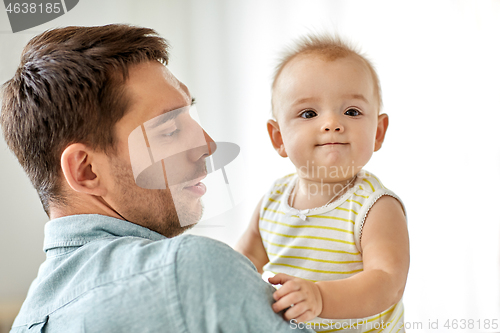 Image of father with little baby daughter at home