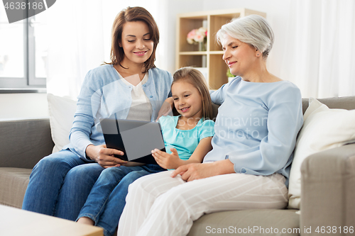 Image of mother, daughter and grandmother with tablet pc