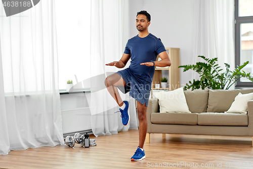 Image of indian man running on spot at home