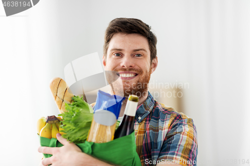 Image of smiling young man with food in bag