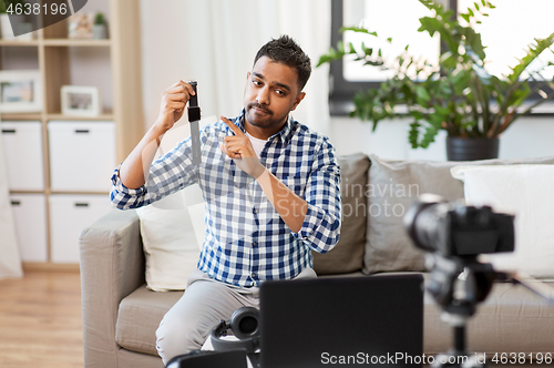 Image of male blogger with smart watch recording video blog